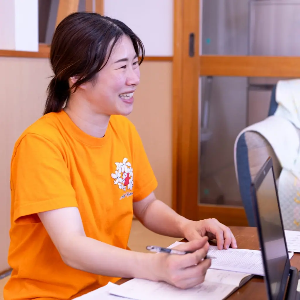 笑顔で日誌を書く調理師